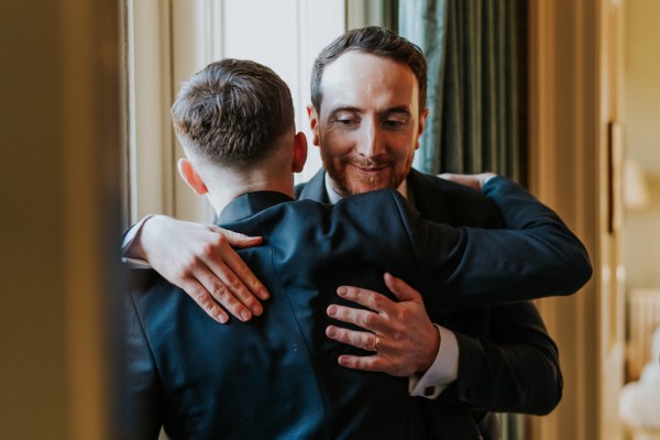 groom hugs groomsman