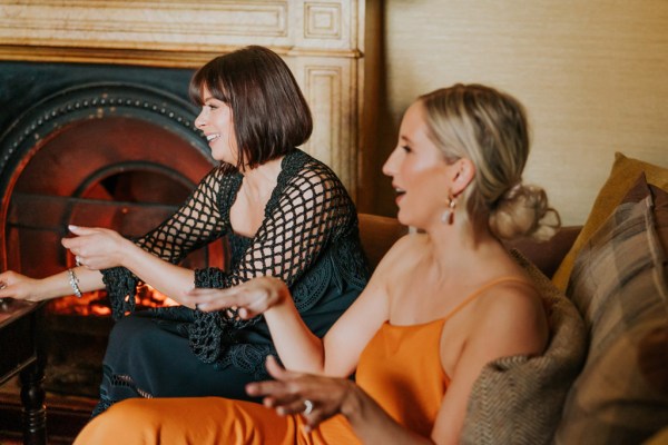 woman in orange dress chats away