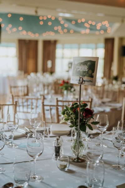 interior dining room setting table chairs lights candles close up flowers