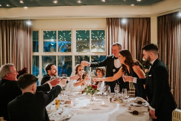 laughing bride groom and guests at table speeches are taking place