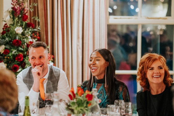 laughing woman and man sitting at dining room table