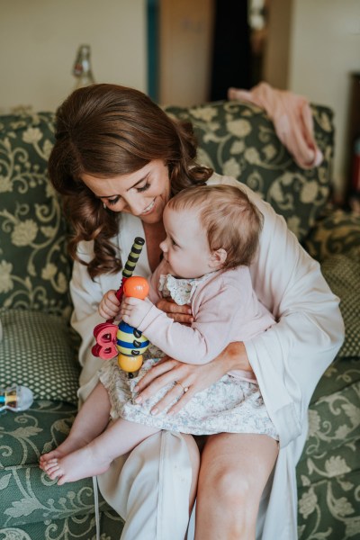 mother and babygirl daughter playing she sits on her lap