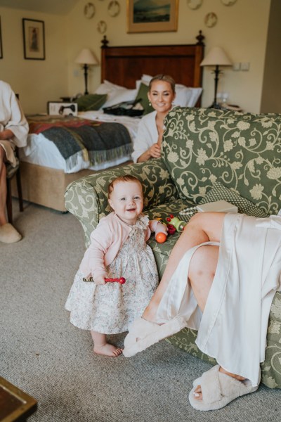 little girl and mother bride sits as daughter plays