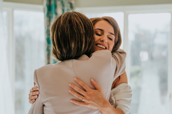 mother and daughter hug mother of the bride