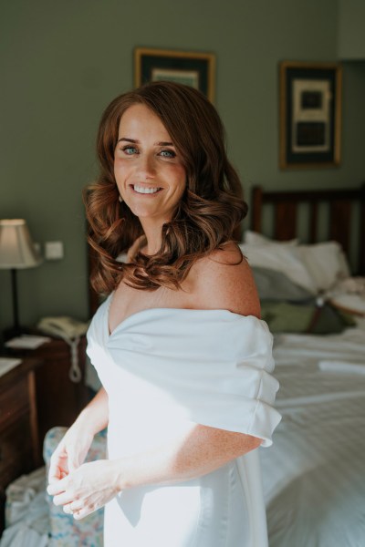 bride faces camera with a big smile on her face