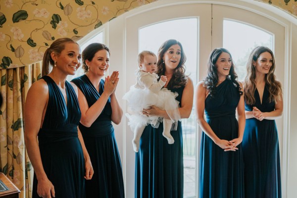 bridesmaids and little girl in white dress clap smile