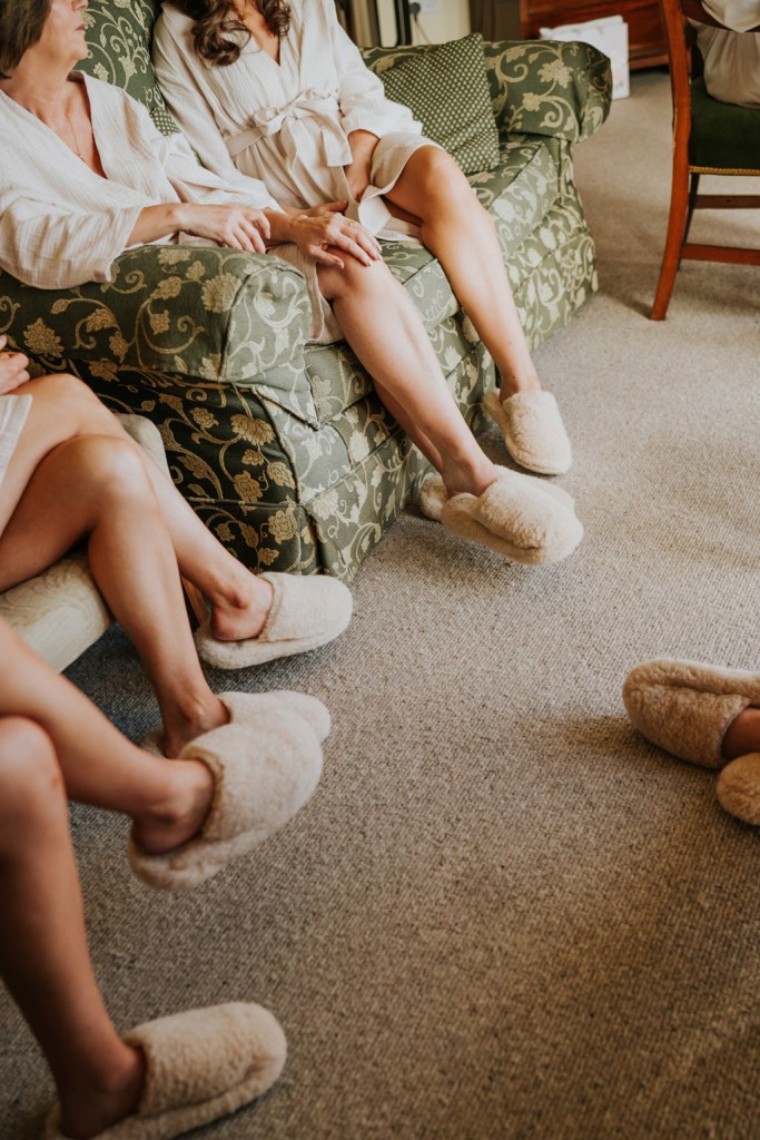 bridesmaids and bride slippers feet sitting down