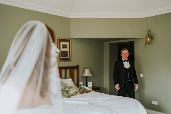 father of the bride walks into room to see his daughter for the first time