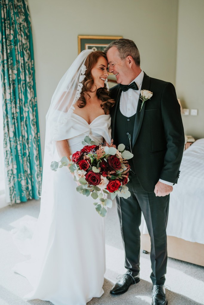 father of the bride walks into room they touch foreheads smiling