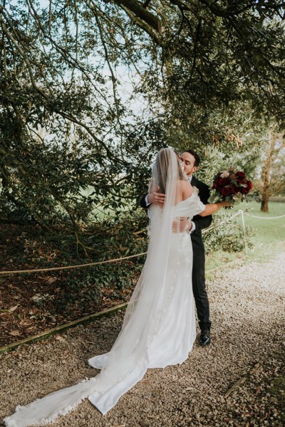 bride and groom embrace hug in garden setting