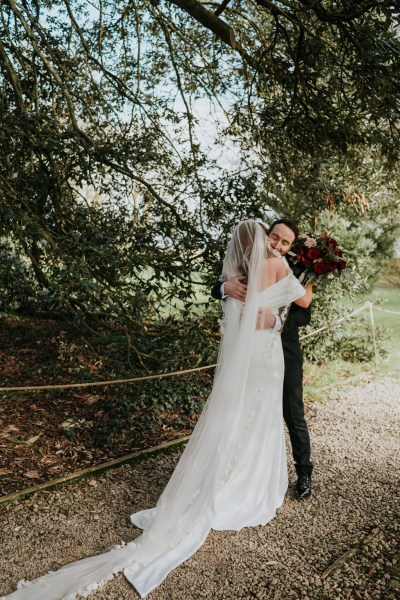 bride and groom embrace hug in garden setting