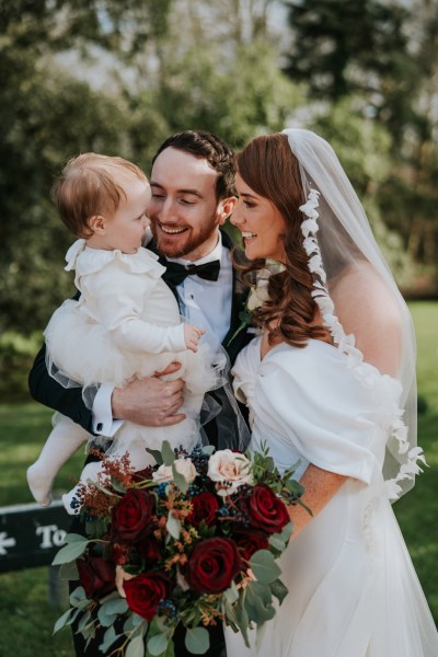 bride groom and little babygirl wearing white dress