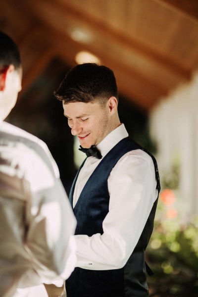 groom looking down getting ready