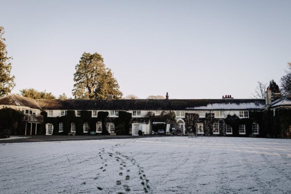 footsteps on snow grass venue in background