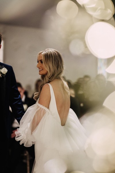 lights and bride from behind smiling