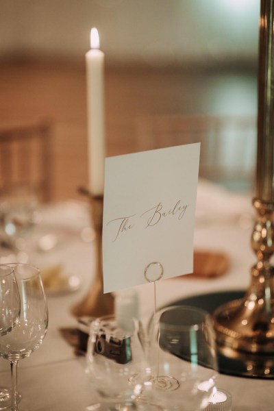 table setting with name on card cutlery gold candles lighting