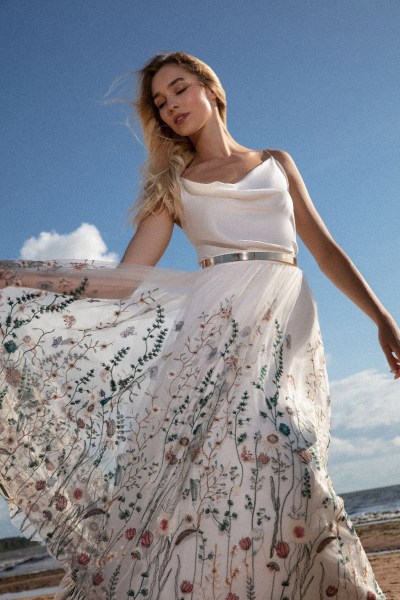 SADONI 2024 brides dress blowing in the wind sky view behind beach setting