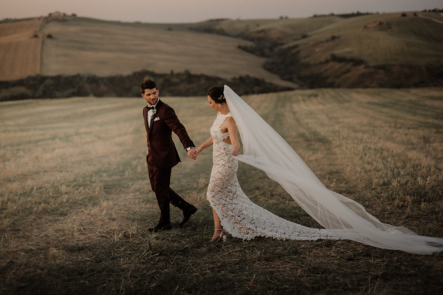 Bride and groom walk outside during Italian wedding