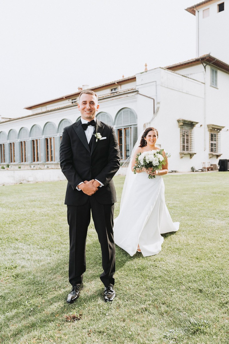 Bride and groom first look during black-tie garden wedding